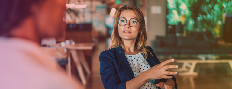 Banner for Harrassment In The Workplace with a corporate woman explaining